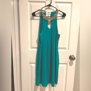 Green Cocktail party dress, rhinestones around the neck, side zipper, open back.